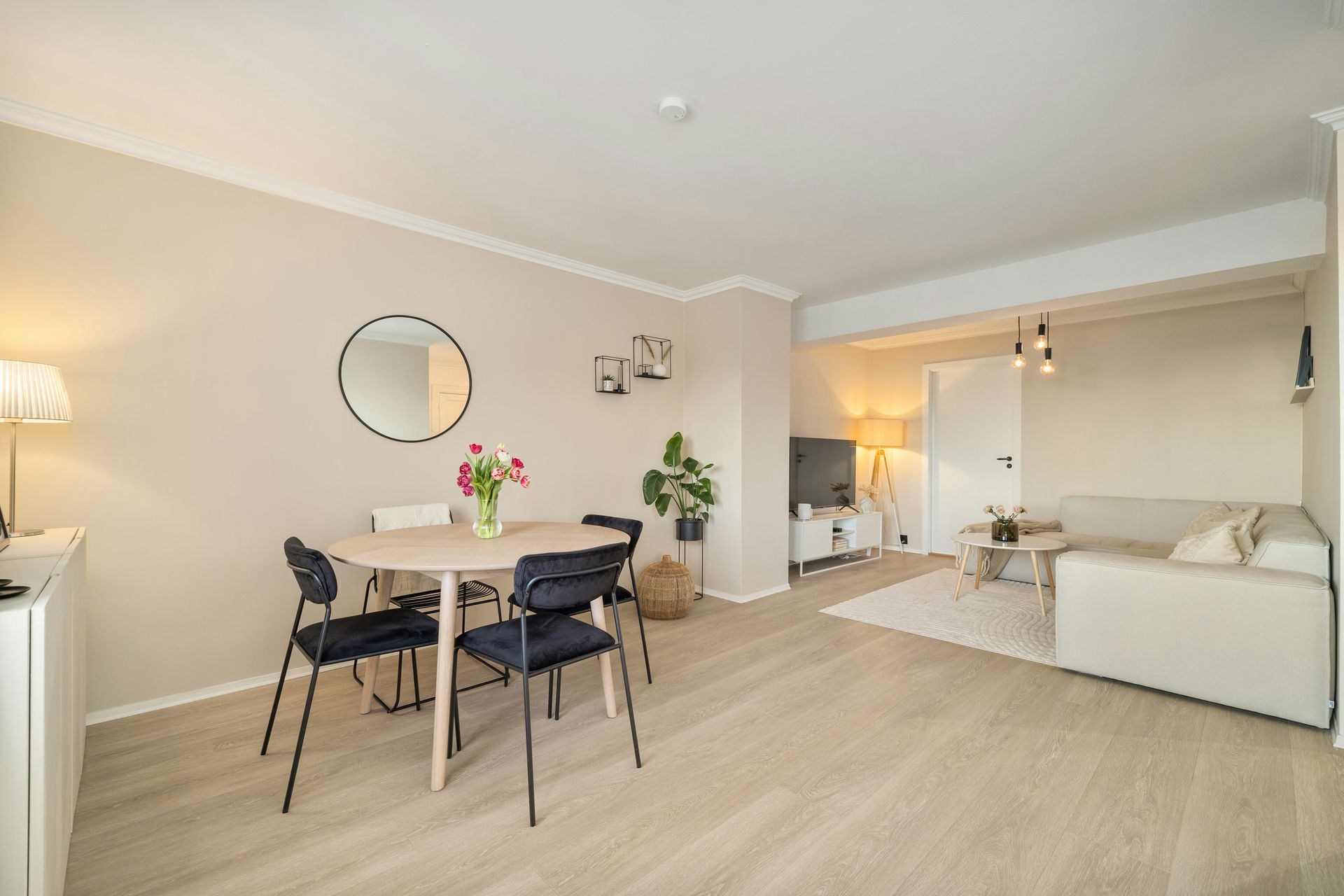 A living room filled with furniture and a dining room table